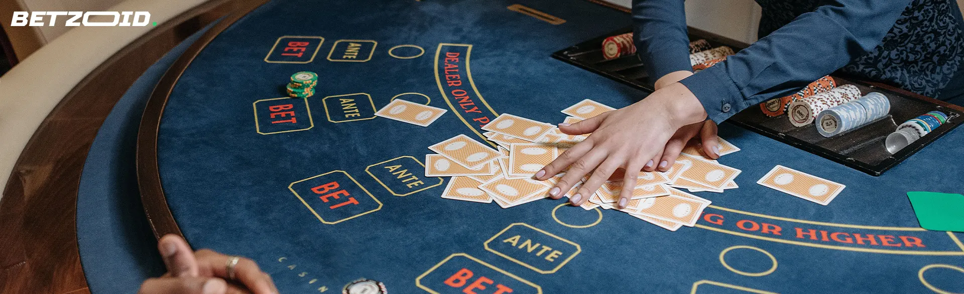 The croupier holds cards on the casino table.