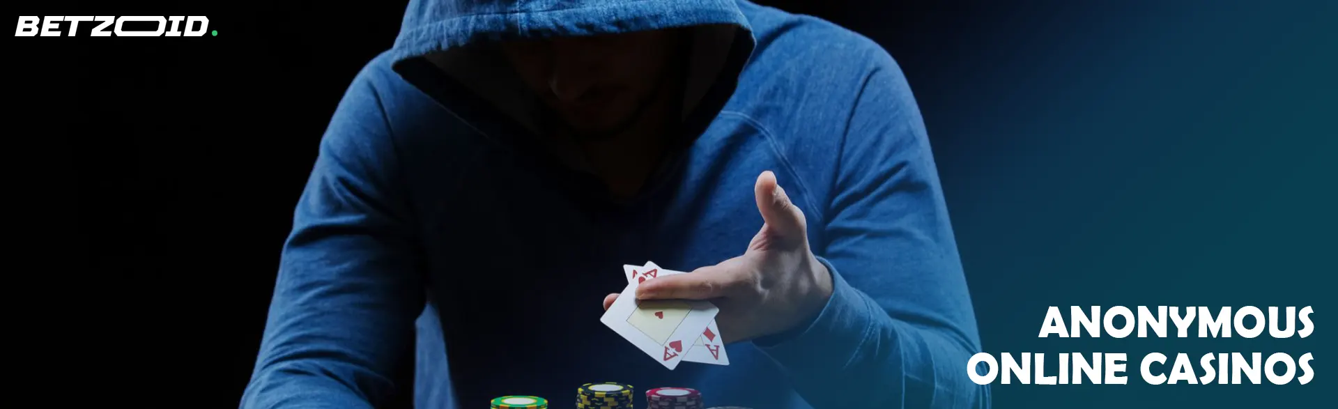 A player in a hood holds cards.
