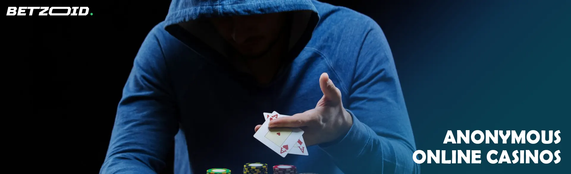 A player in a hood holds cards.