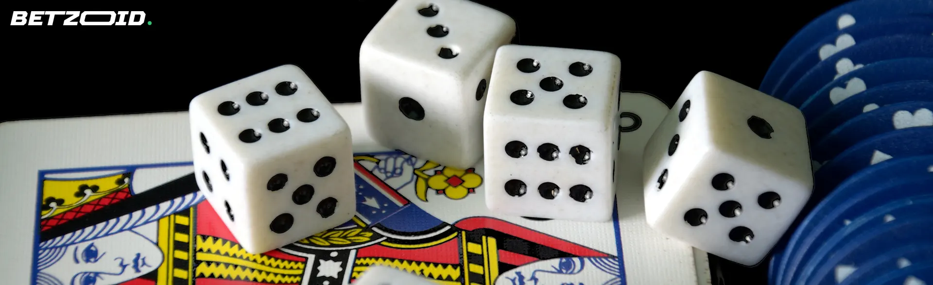 Dice and casino chips lie on the cards.