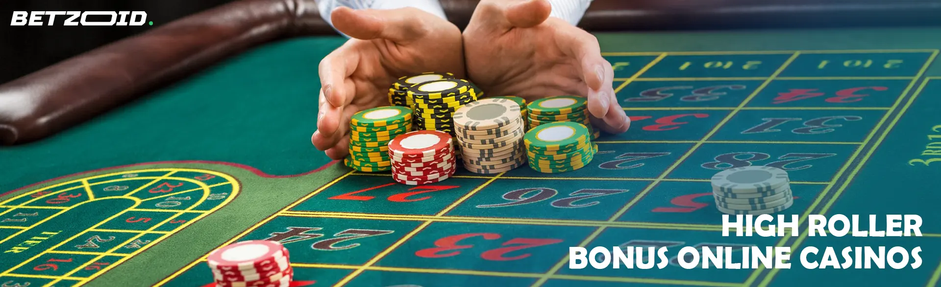 A player holds a pile of chips on a casino table.