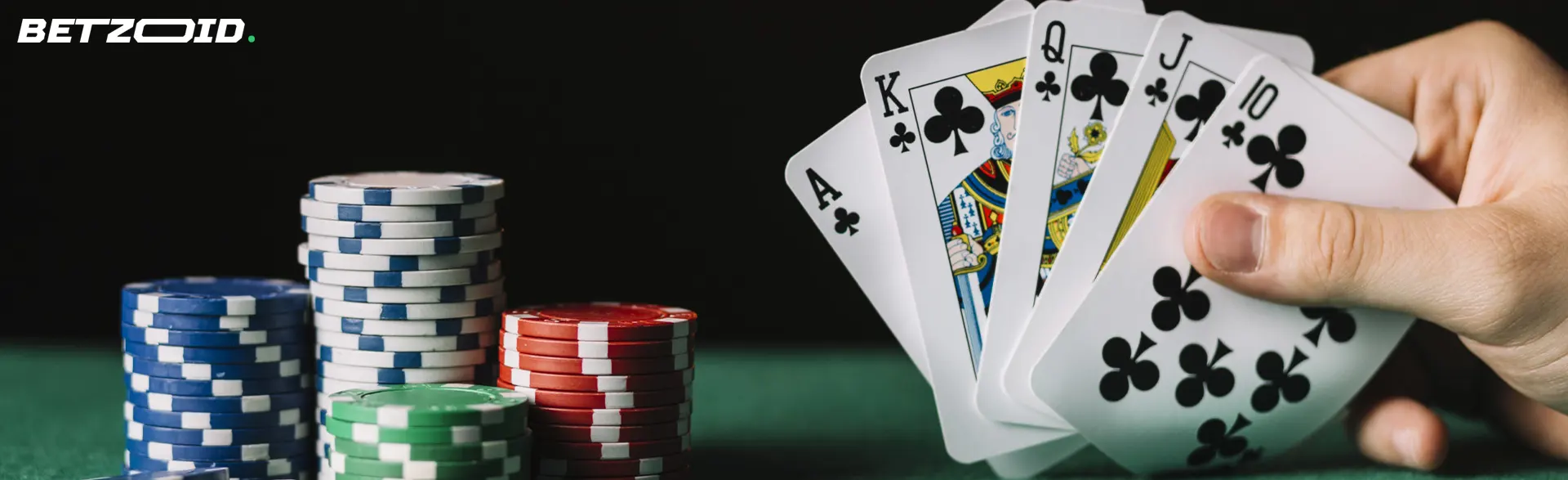 The player holds cards next to casino chips.