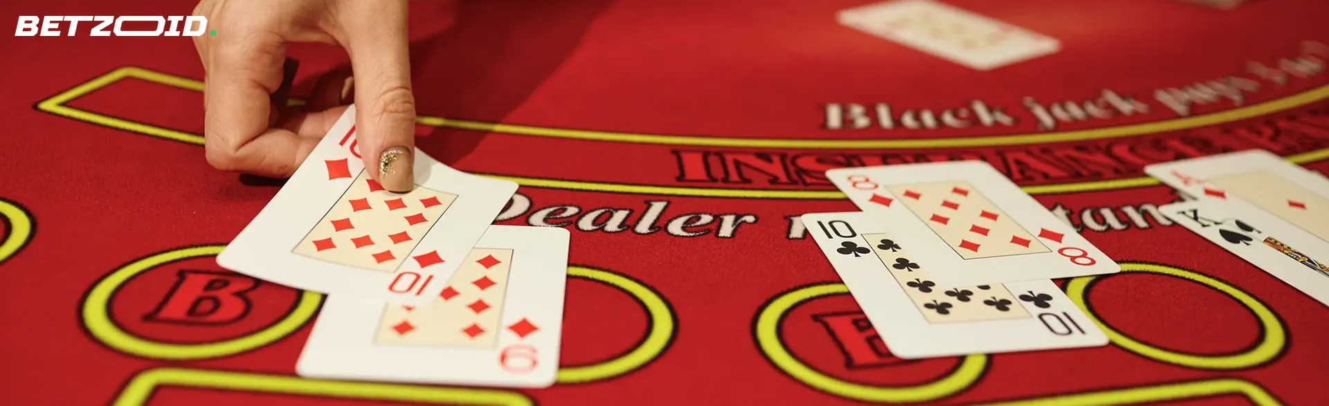 The player places cards on the casino table.