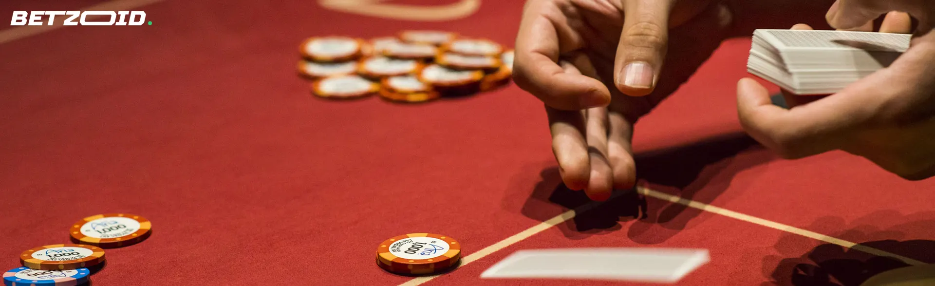 Ein Spieler legt Karten auf einem Casinotisch aus.