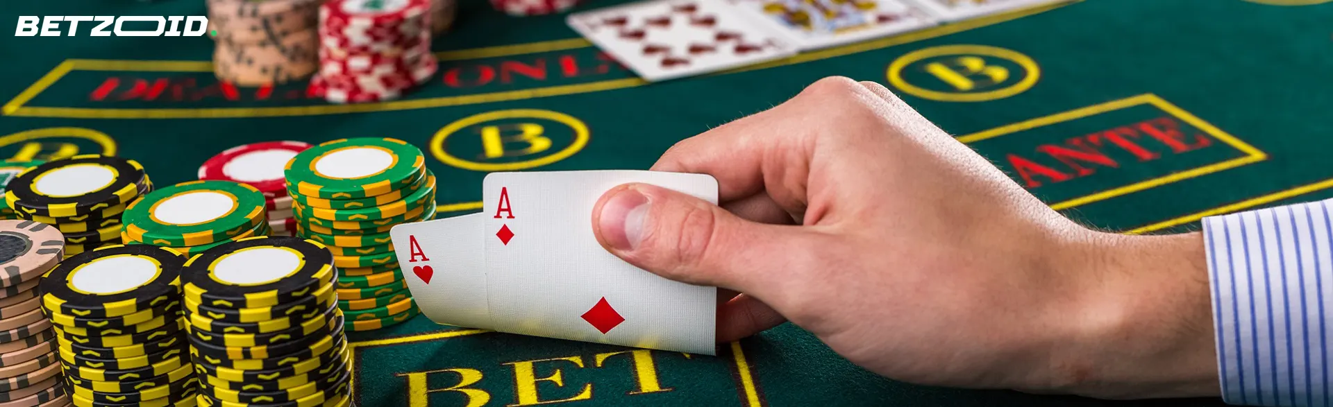El jugador sostiene cartas junto a las fichas del casino.