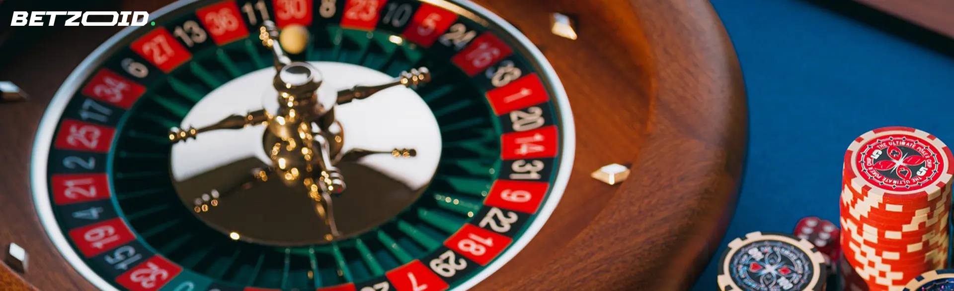 Roulette wheel next to casino chips.