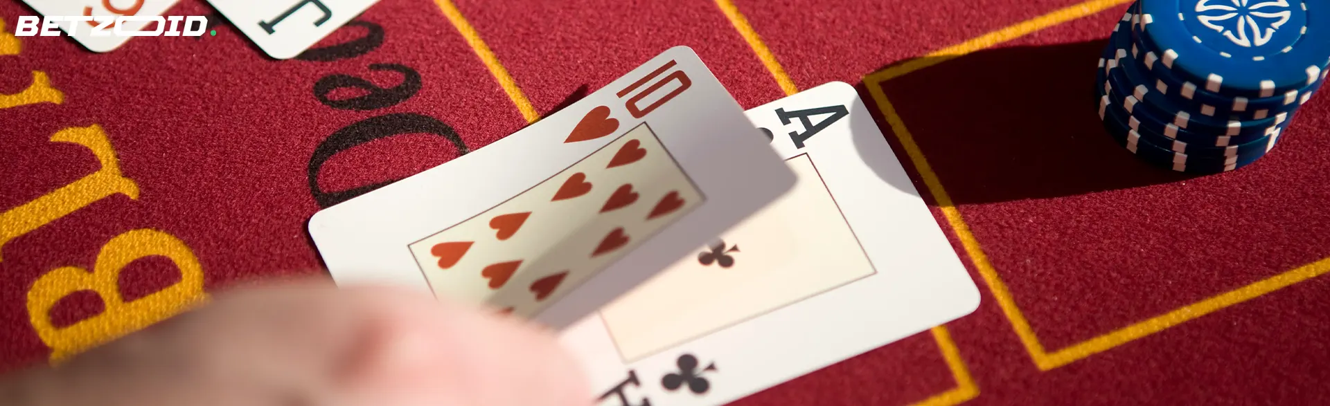 The player places cards on the casino table.