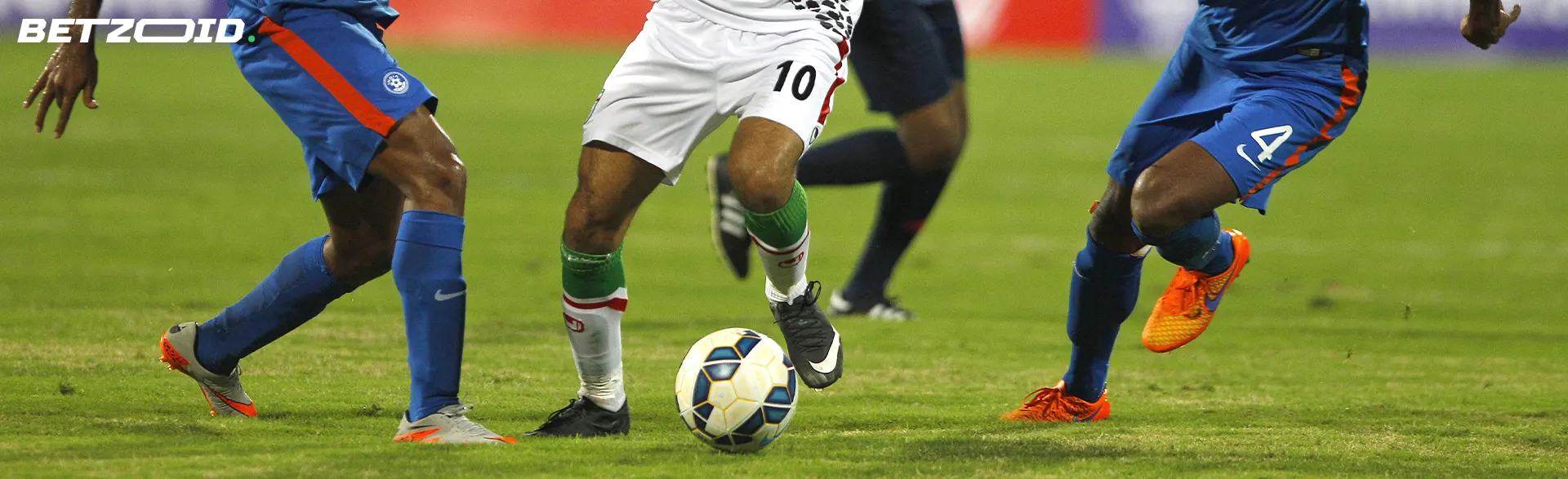 Football players fight for the ball during a game.