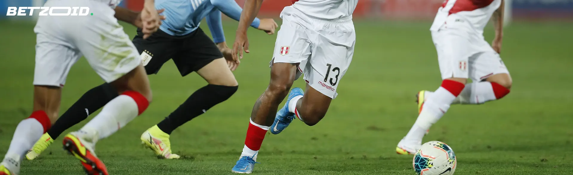 Football players fight for the ball during a match.