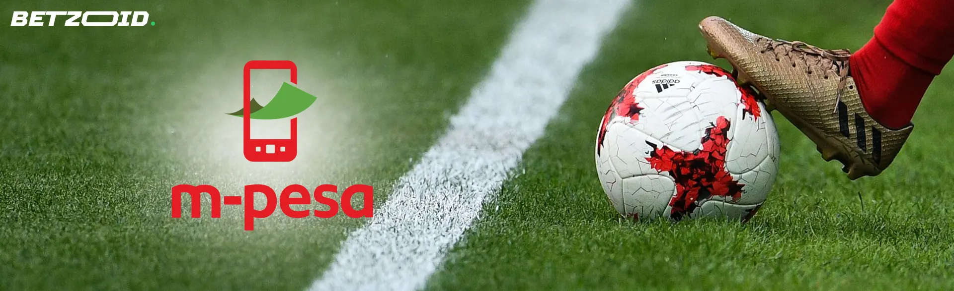 A football player holds the ball with his foot.