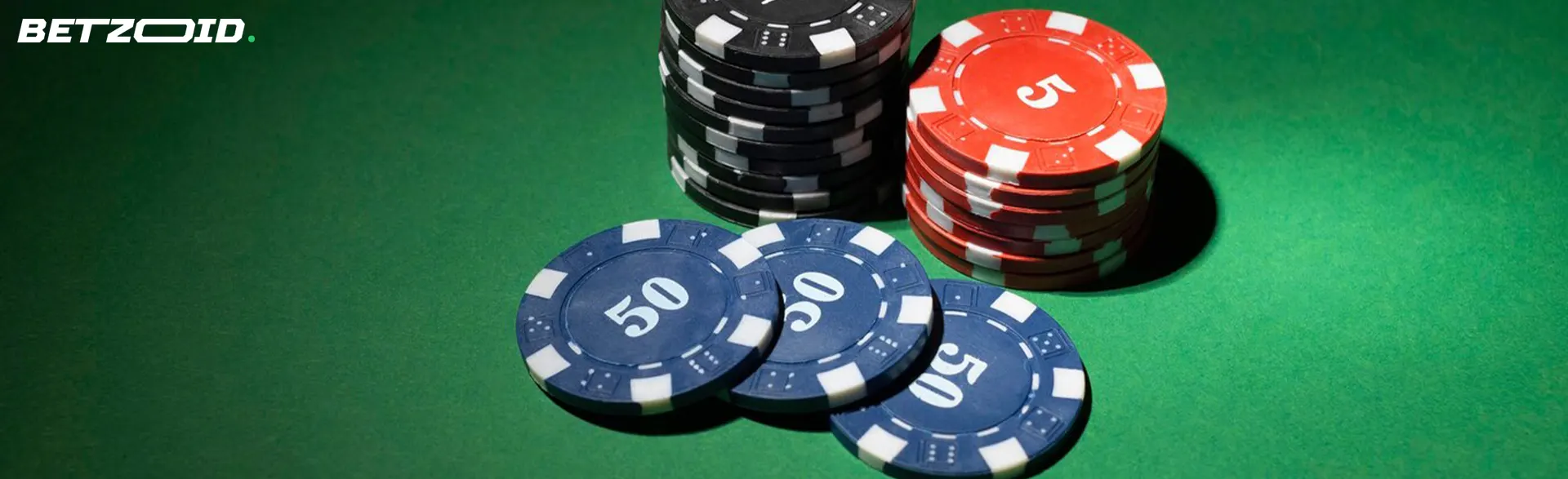 Chips of different denominations on a green background.