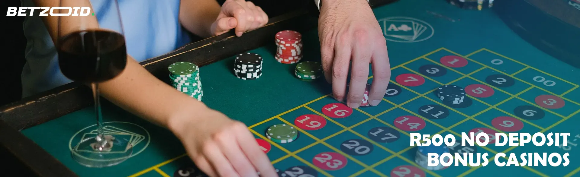 Players place bets with chips on a casino table.