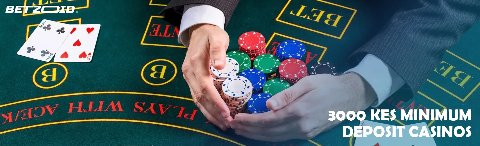 A player holds a pile of chips on a casino table.