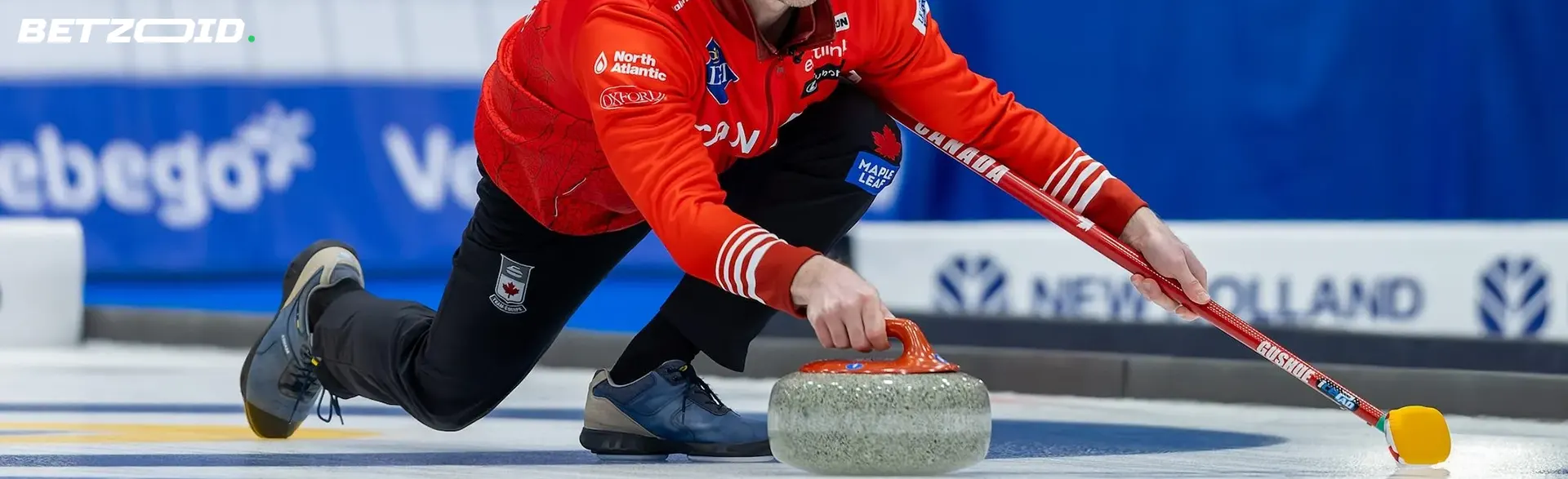 A curler pushes a stone on the ice.