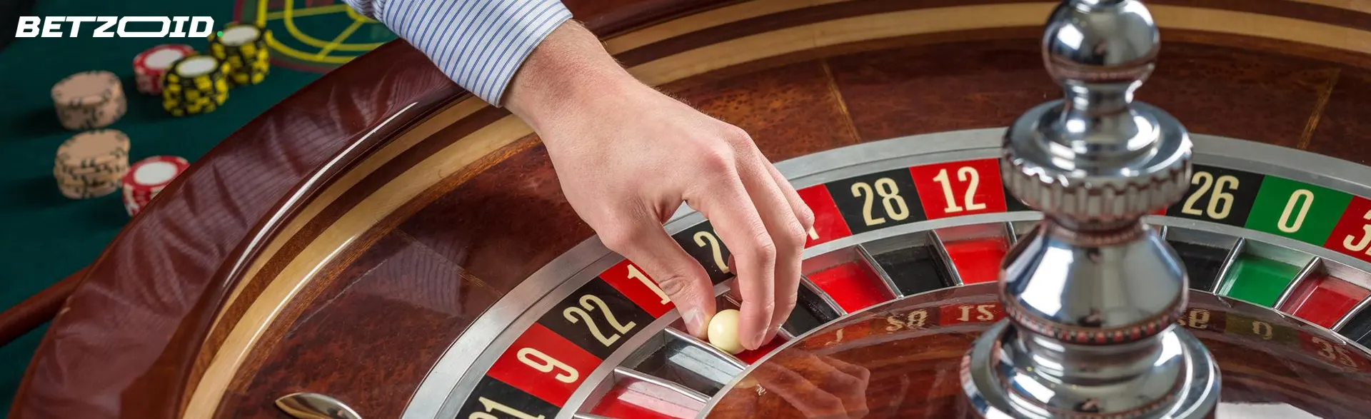 The player places the ball on the roulette wheel.
