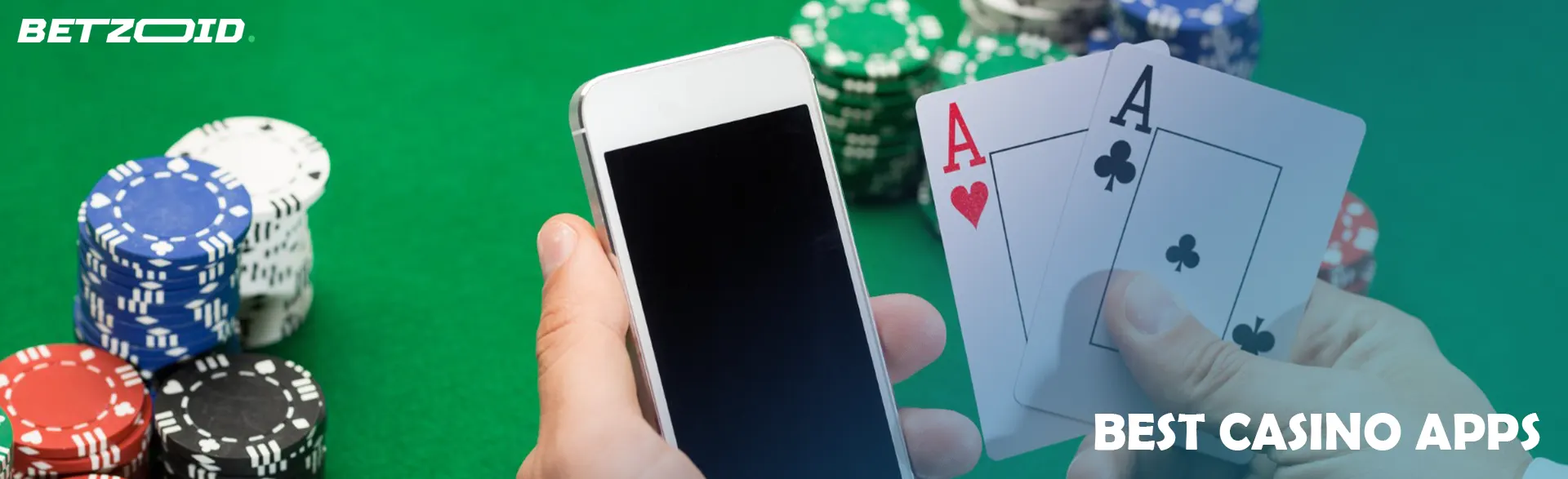Player holds smartphone and cards next to casino chips.