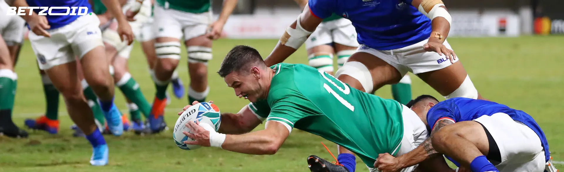 Rugby players fight for the ball during a game.