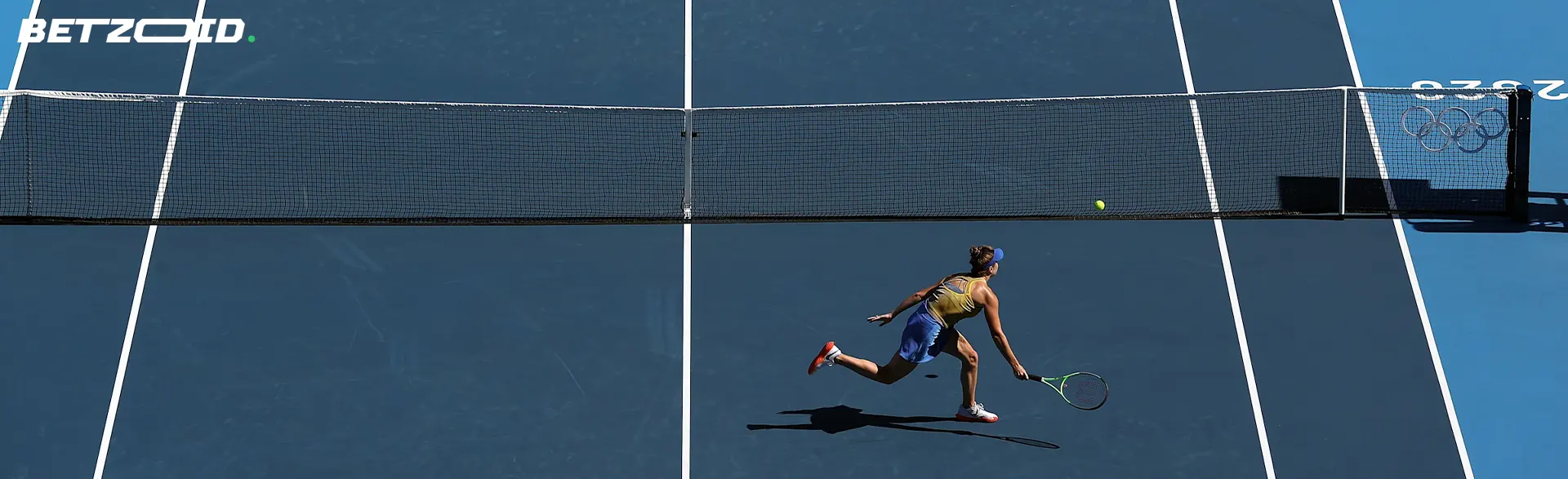 A tennis player is playing on the court.