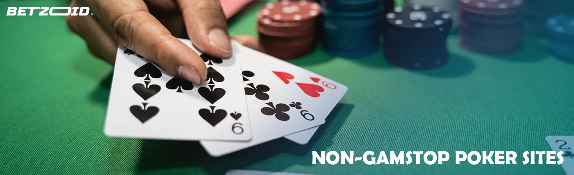 The player holds cards next to casino chips.