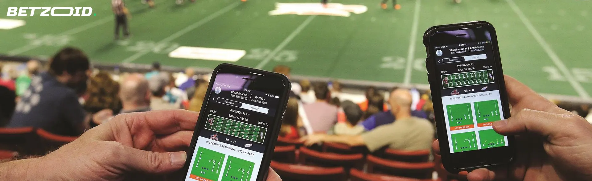 People with smartphones in the stands.