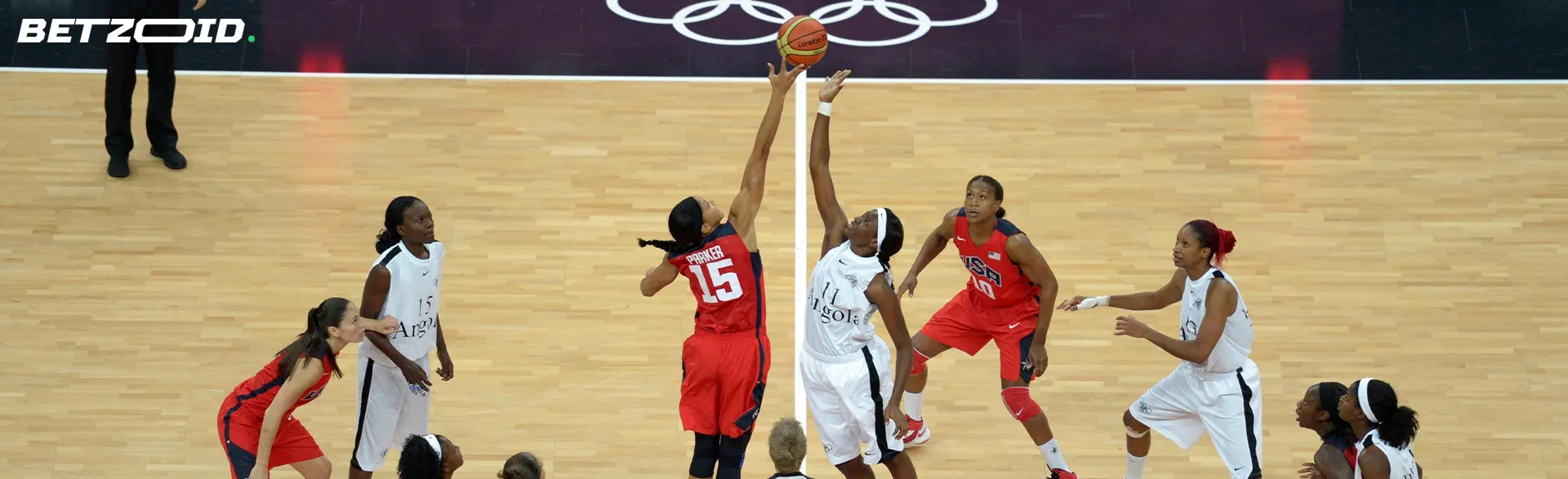 Basketball players play through the net.