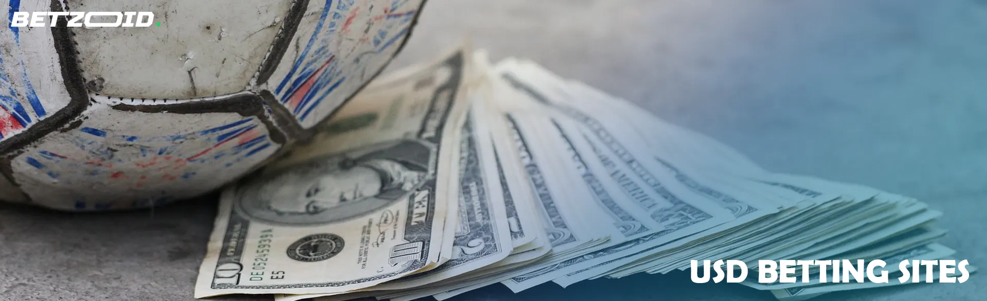 Dollar bills next to a soccer ball.