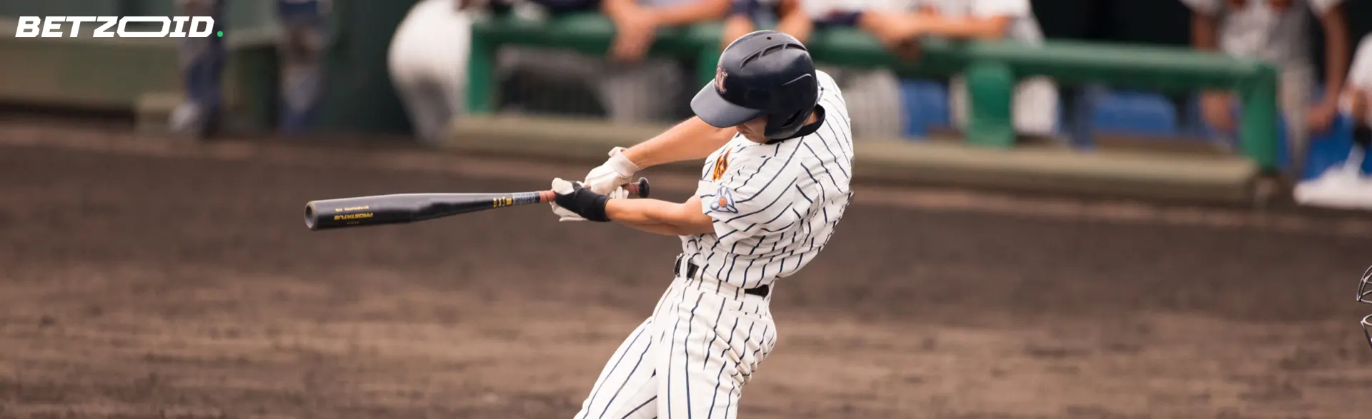 A baseball player tries to hit the ball.