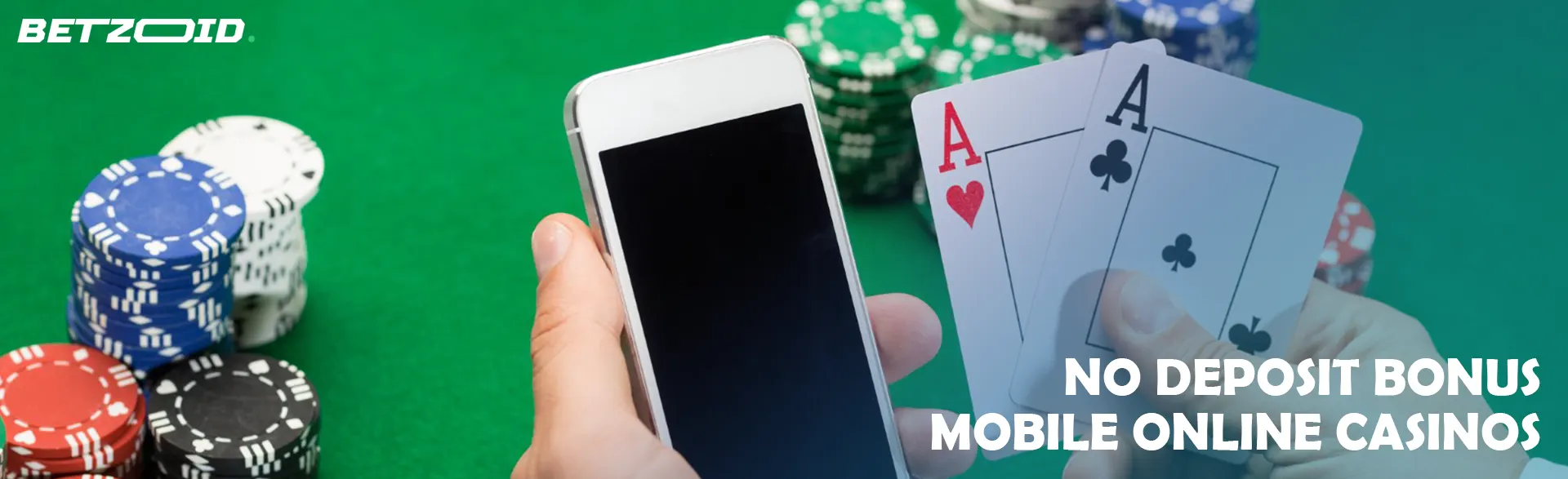  A player holds cards and a smartphone against the backdrop of a casino table.