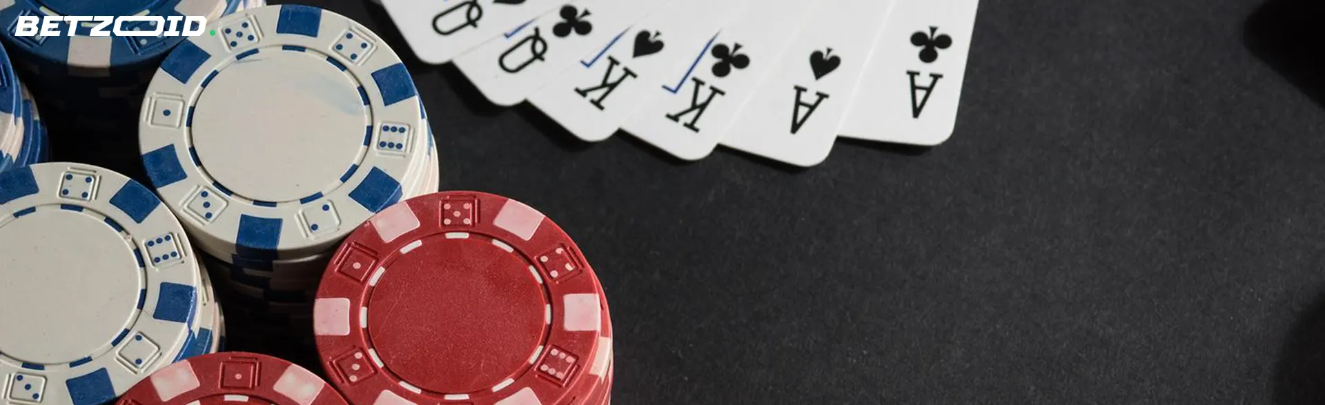 Fichas junto a cartas sobre un fondo gris.