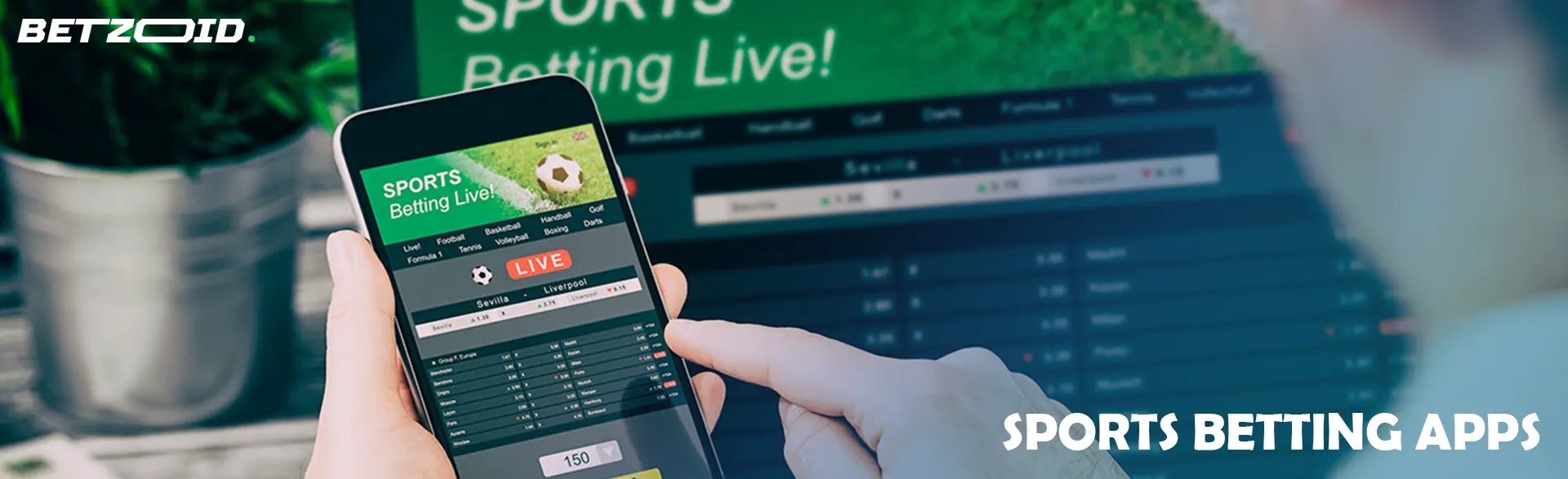 Smartphone with betting apps in front of a laptop.