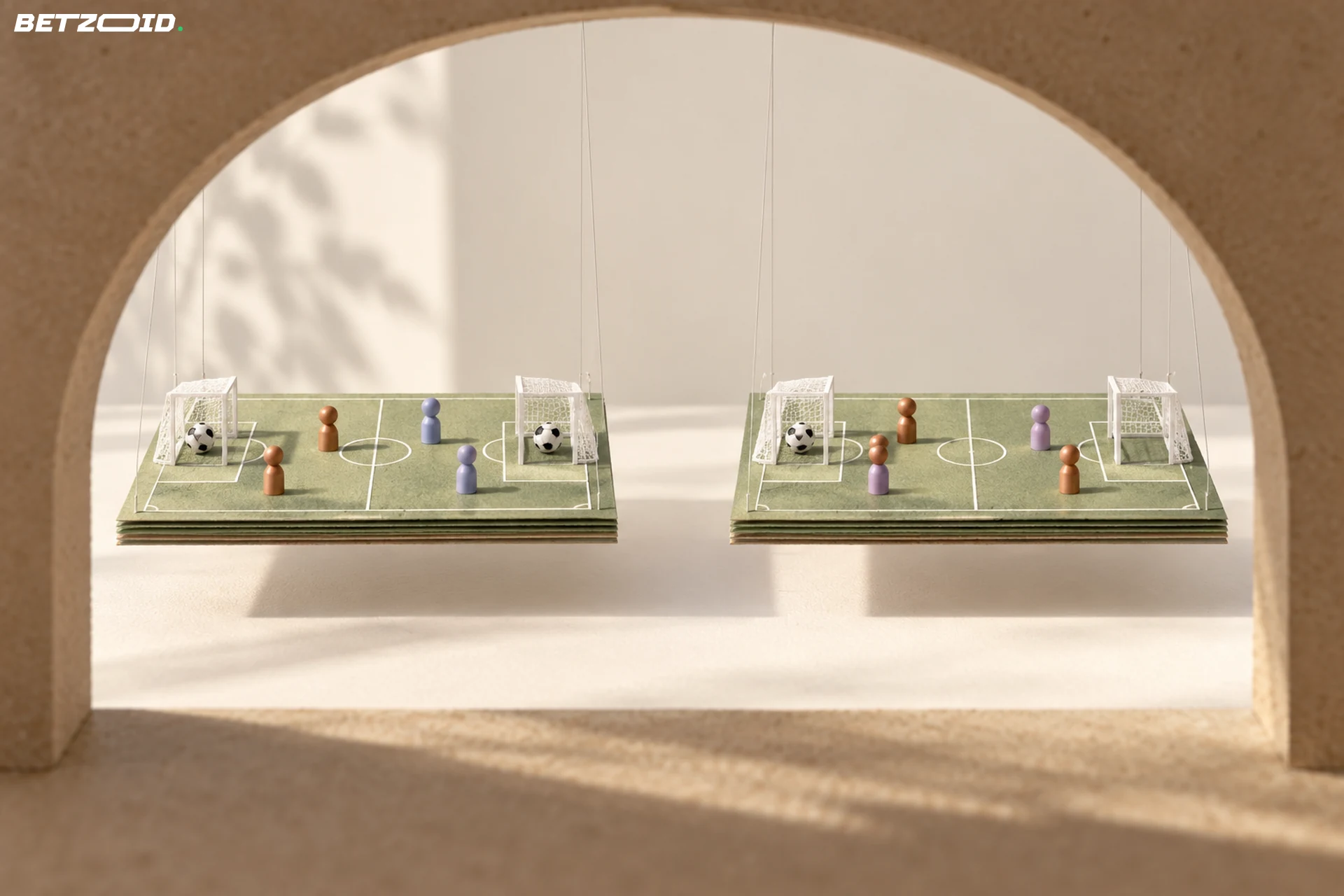 Zwei schwebende Spielfeldmodelle zeigen Bälle in beiden Toren beziehungsweise nur in einem Tor.
