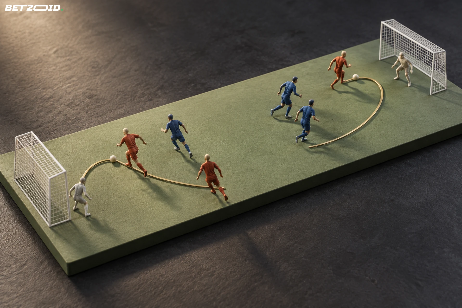 Miniature soccer players and curved brass routes arranged between two opposite goal frames.